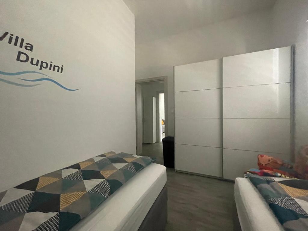 Postel nebo postele na pokoji v ubytování Villa Dupini