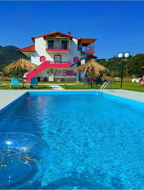 a house with a swimming pool in front of a house at Vigla House in Sykia Chalkidikis