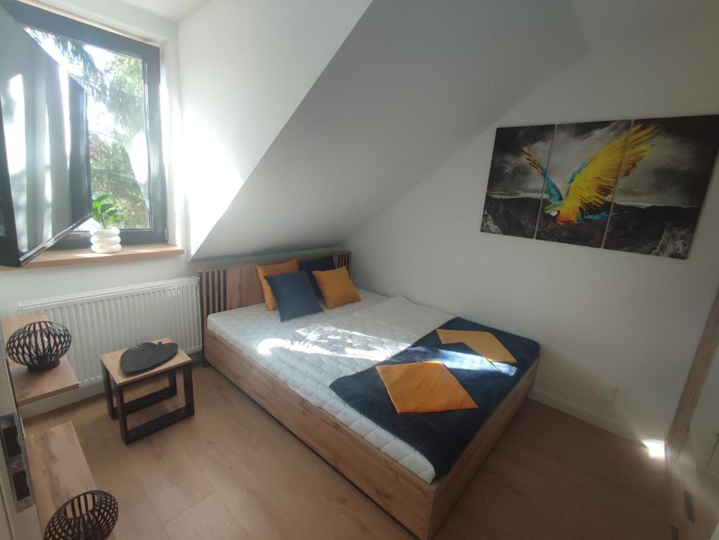 a bedroom with a bed and a picture on the wall at Luksusowy Apartament EDITH Giżycko in Giżycko