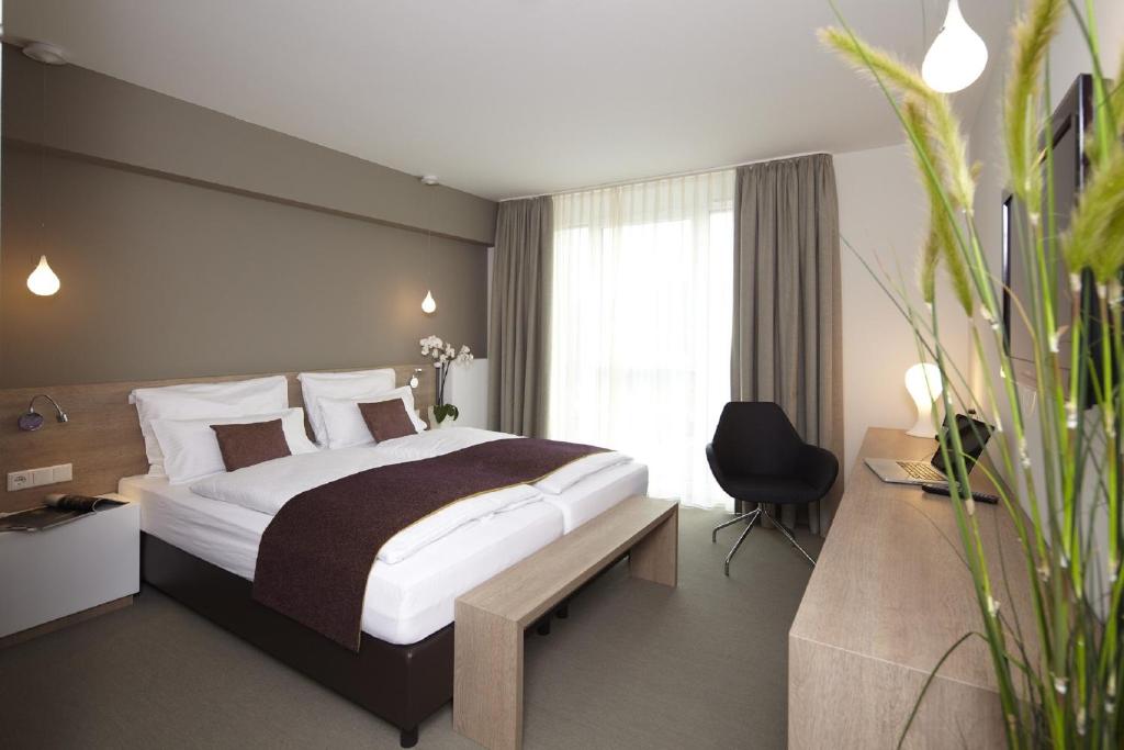 Postel nebo postele na pokoji v ubytování Hotel Kapellenberg
