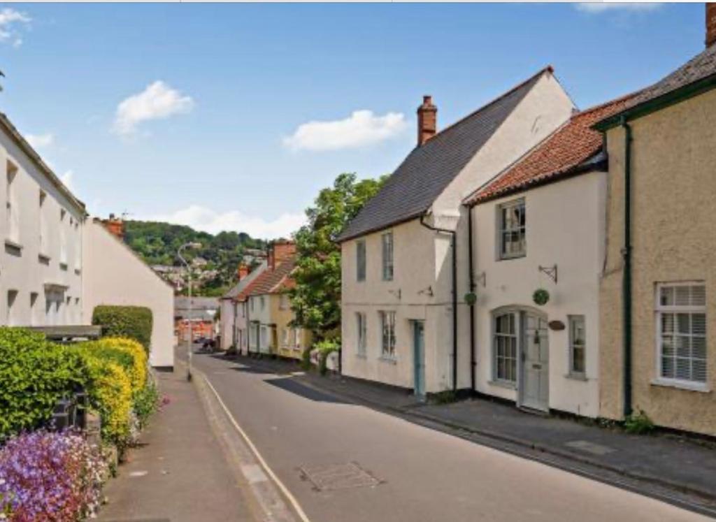 an empty street in a small town with houses at Carpenters Cottage Quirky home Seaside town in Minehead