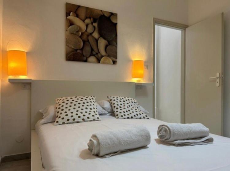 a bedroom with a bed with two towels on it at Bungalow 97 in Fontane Bianche