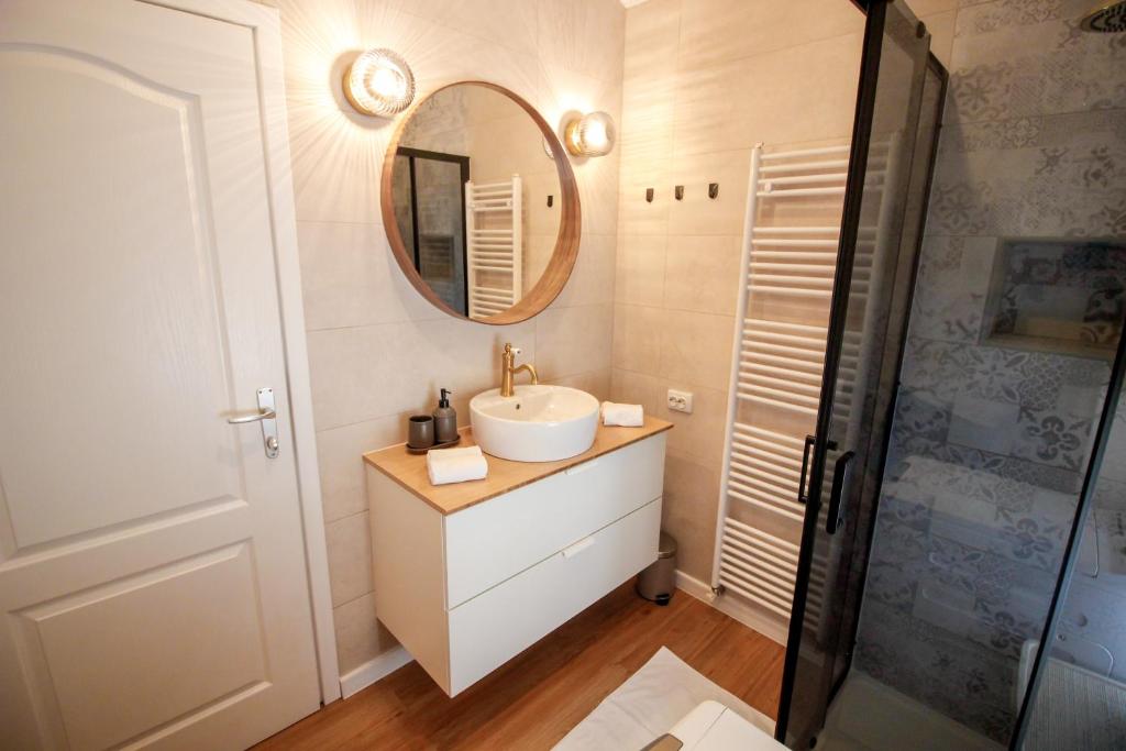 a bathroom with a sink and a mirror at Apartment Castelmuschio in Omišalj