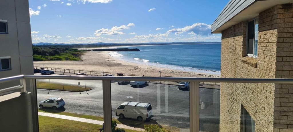 a view of the beach from a balcony of a house at El Sandi 12 in Forster