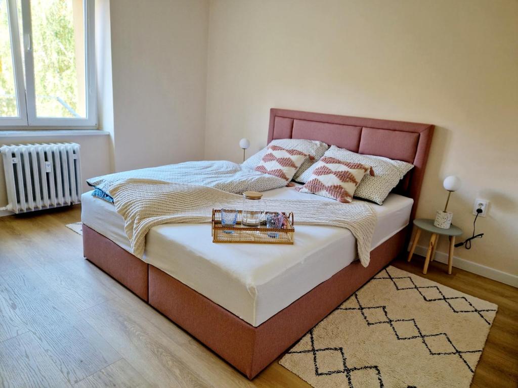 Una cama con una bandeja en un dormitorio en City Center Apartment - Self check-in, en Spišská Nová Ves