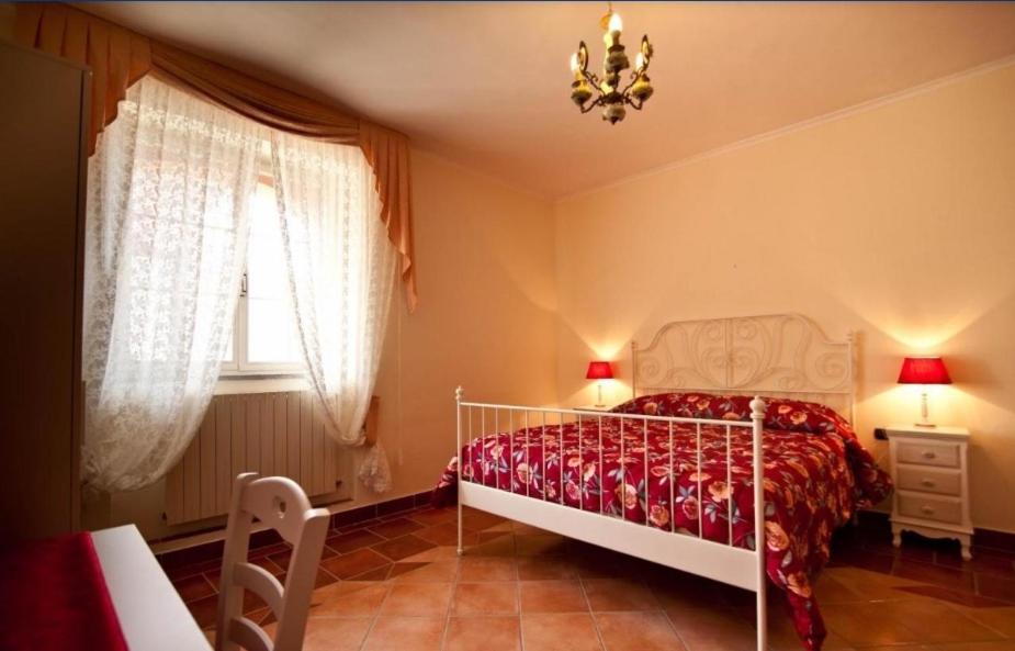 a bedroom with a bed and a chandelier at Locanda il Fienile in Naples