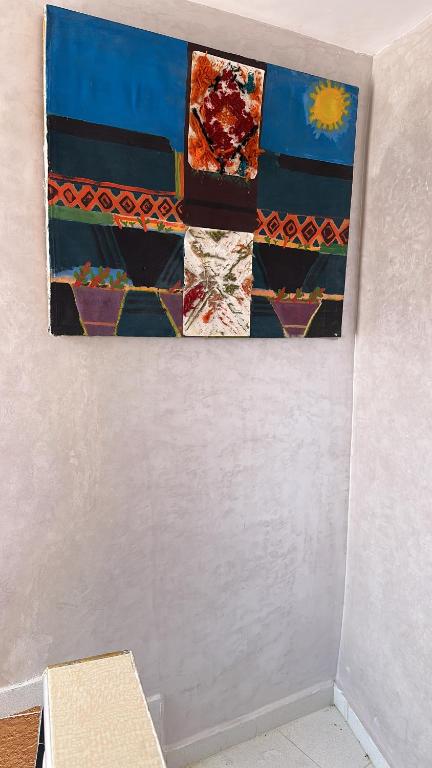 a painting hanging on a wall in a room at House with sea view in Kasbah in Tangier