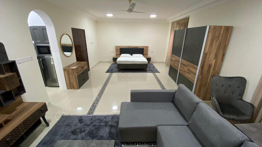 a living room with a couch and a bed at AL KALDi in Salalah