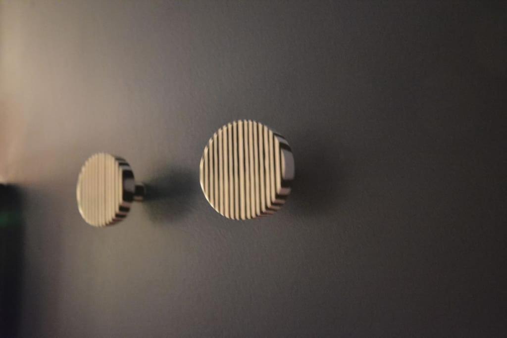 a pair of lights hanging on a wall at Appartement design à la bourse du commerce in Paris