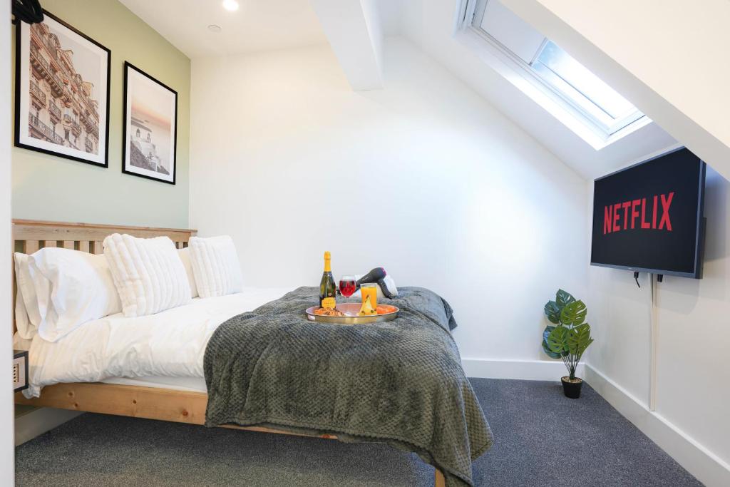 a bedroom with a bed with a table on it at Central Buckingham Apartment #5 with Free Parking, Pool Table, Fast Wifi and Smart TV with Netflix by Yoko Property in Buckingham