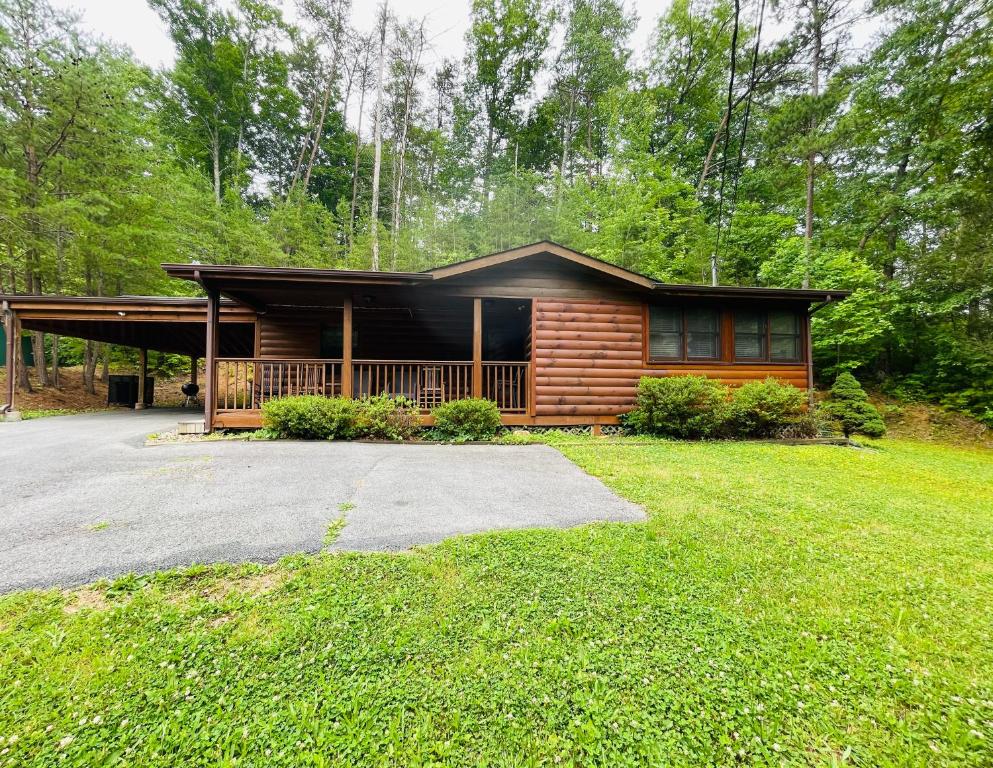a log cabin with a driveway in front of it at Smoky Mountain Enchanting Haven 3BR2BA Cabin in Sevierville