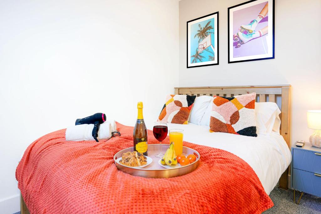 a bed with a tray of food and drinks on it at Central Buckingham Apartment #6 with Free Parking, Pool Table, Fast Wifi and Smart TV with Netflix by Yoko Property in Buckingham