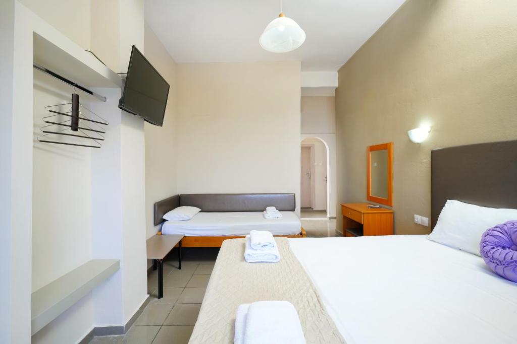 Postel nebo postele na pokoji v ubytování Hotel Papageorgiou