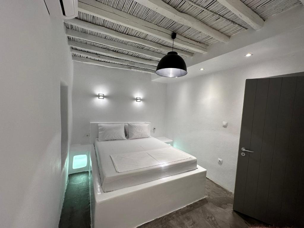 a white room with a bed with lights on it at Naoussa Center Home in Naousa