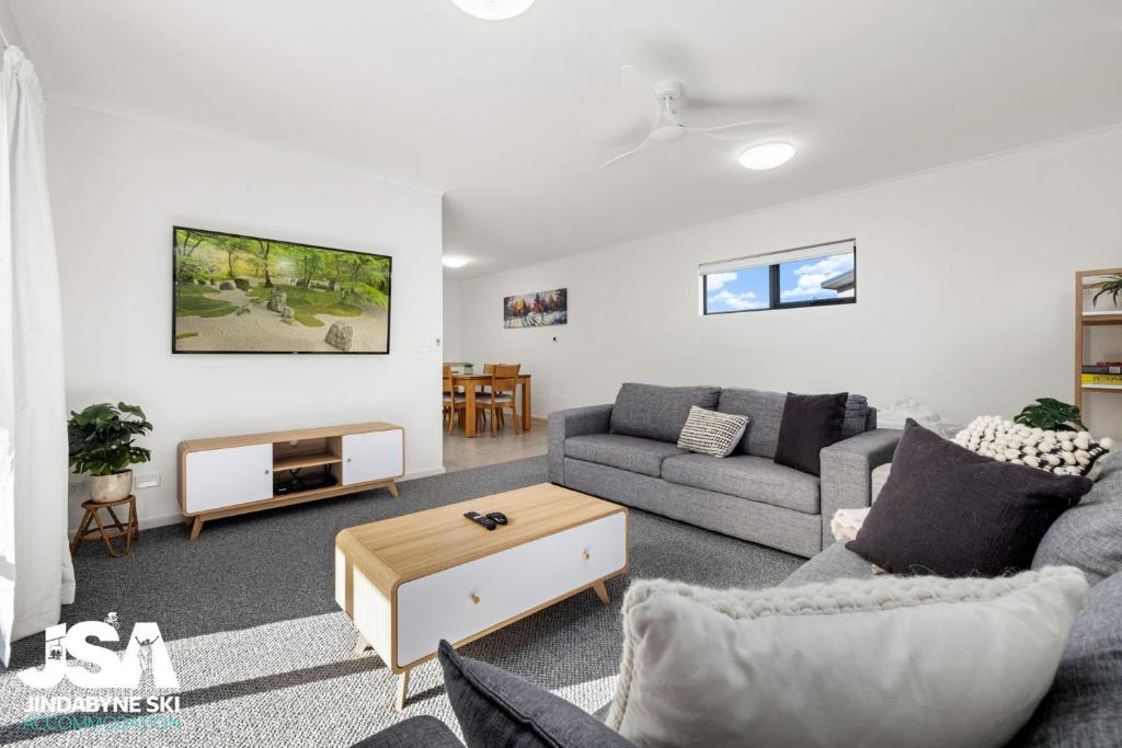 a living room with a couch and a table at Berridale Bliss in Berridale