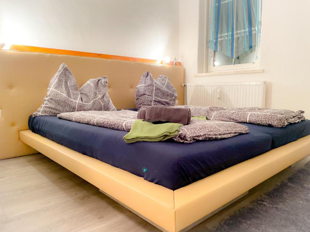a bed with blankets and pillows on it in a room at Charmante Ferienwohnung in St. Barbara im Mürztal in Grossveitscherthal