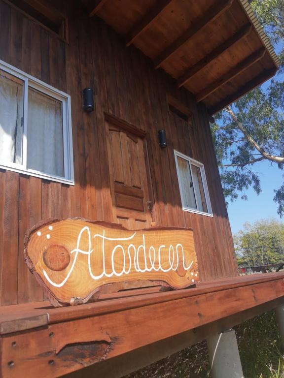 a sign on the side of a wooden house at Cabañas Ollagua in Punta Indio