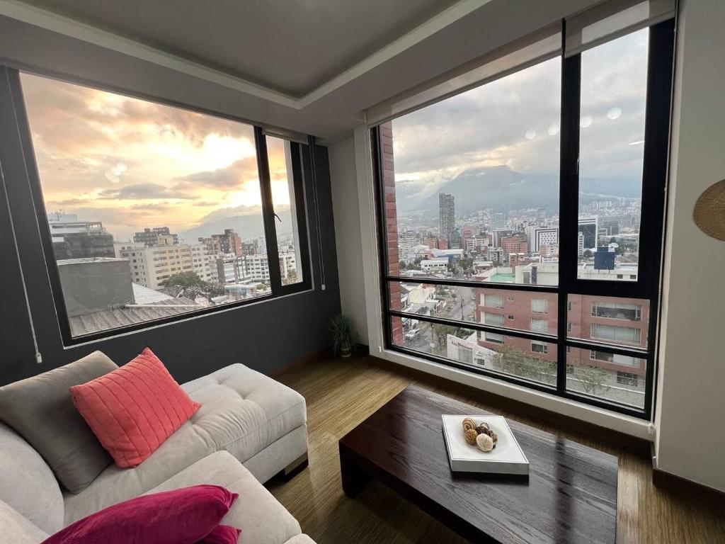 a living room with a white couch and large windows at NEW! Modern 2b La Carolina AmazingView 3c in Quito