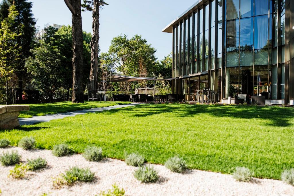 a green lawn in front of a building at Crowne Plaza Porto, an IHG Hotel in Porto