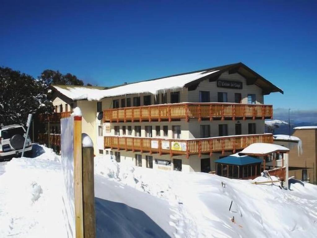 a building with snow on the ground in front of it at Mount Buller Apartment in Mount Buller