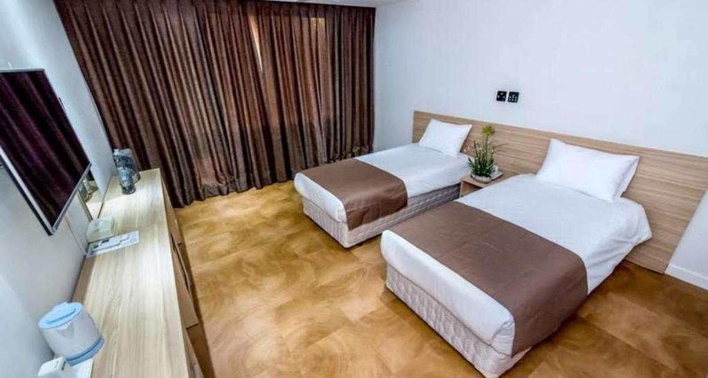 Postel nebo postele na pokoji v ubytování Jeju In Hotel