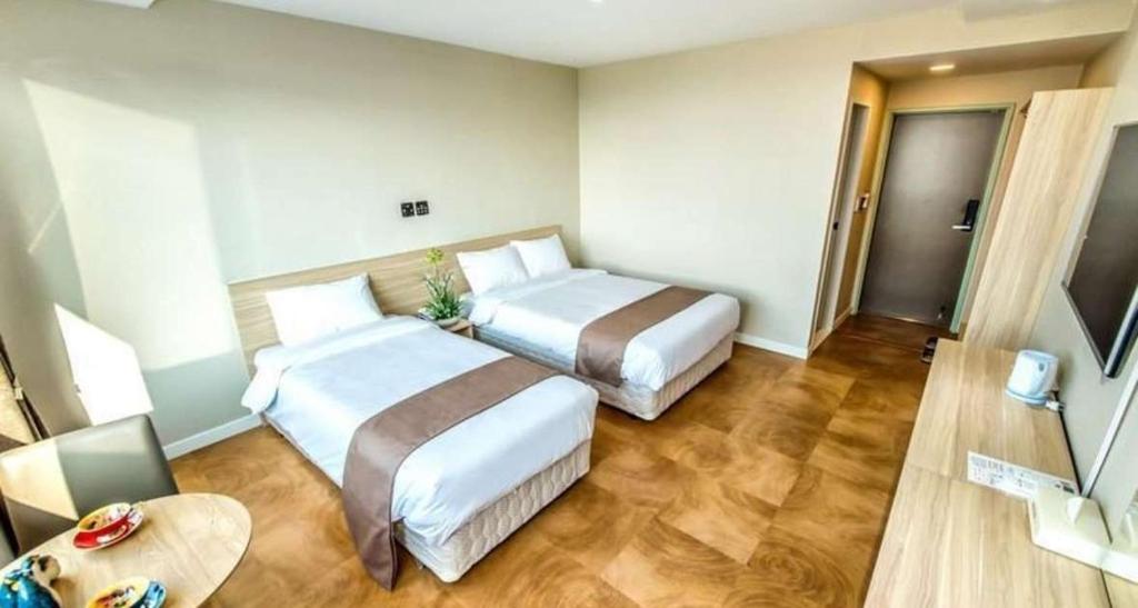 Postel nebo postele na pokoji v ubytování Jeju In Hotel
