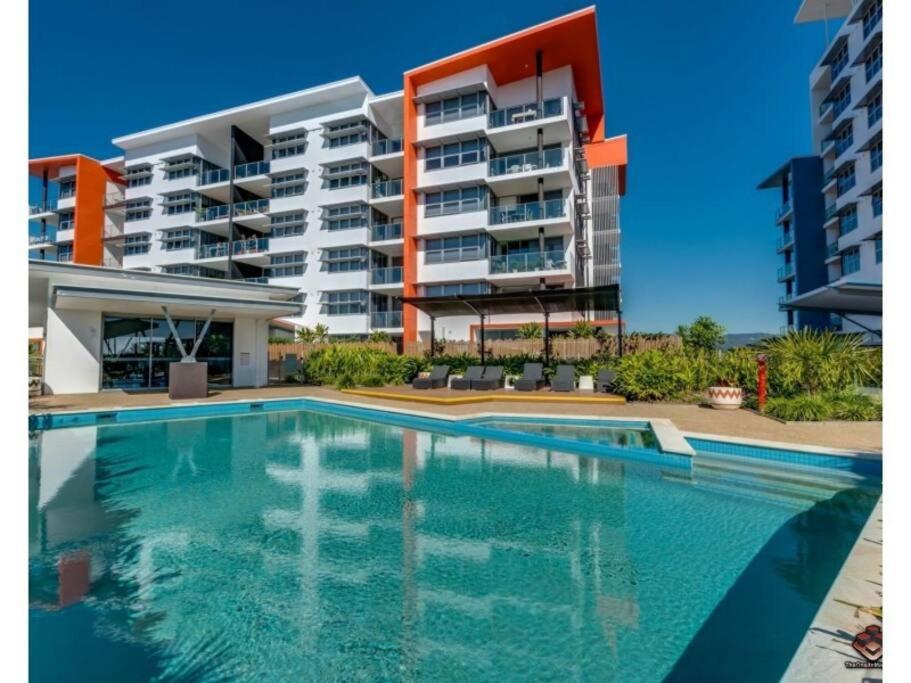 a swimming pool in front of a apartment building at Two bedroom Apartment in Robina Center in Gold Coast