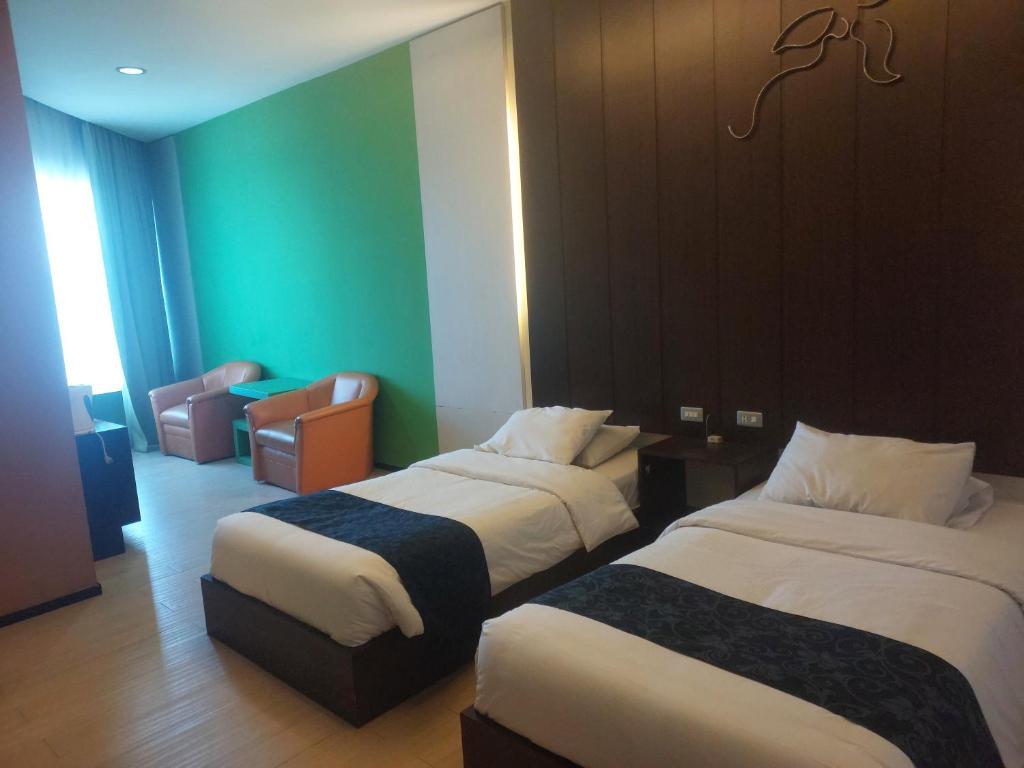 Postel nebo postele na pokoji v ubytování Hotel New Puri Garden