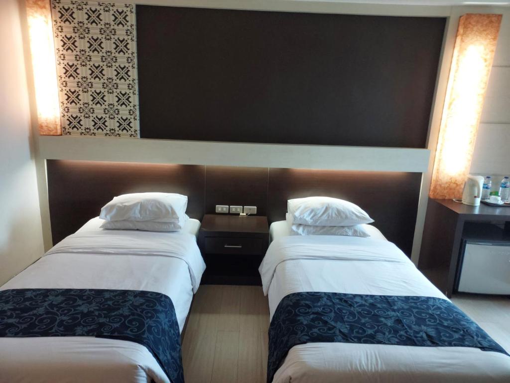 Postel nebo postele na pokoji v ubytování Hotel New Puri Garden