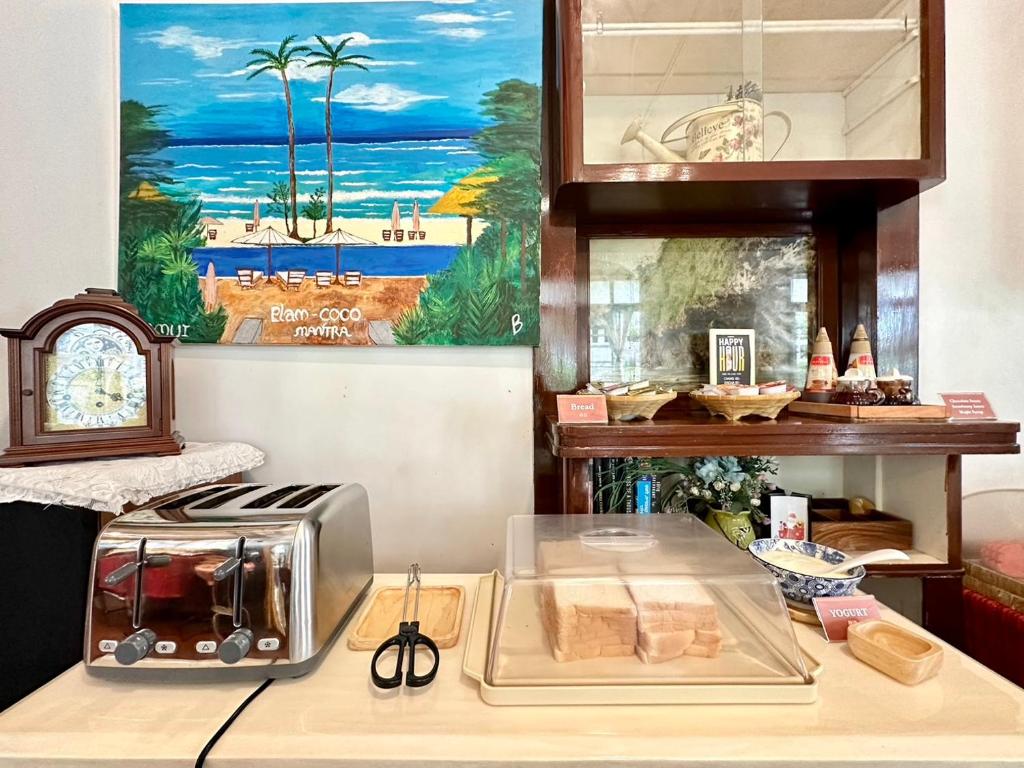 A toast station with a four-slot toaster, sliced bread and scissors for serving.