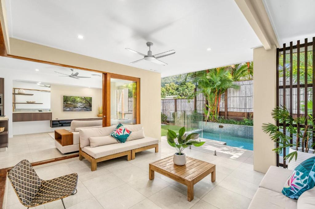 an image of a living room with a pool at Belle Escapes Havenly Luxury Villa Palm Cove in Palm Cove