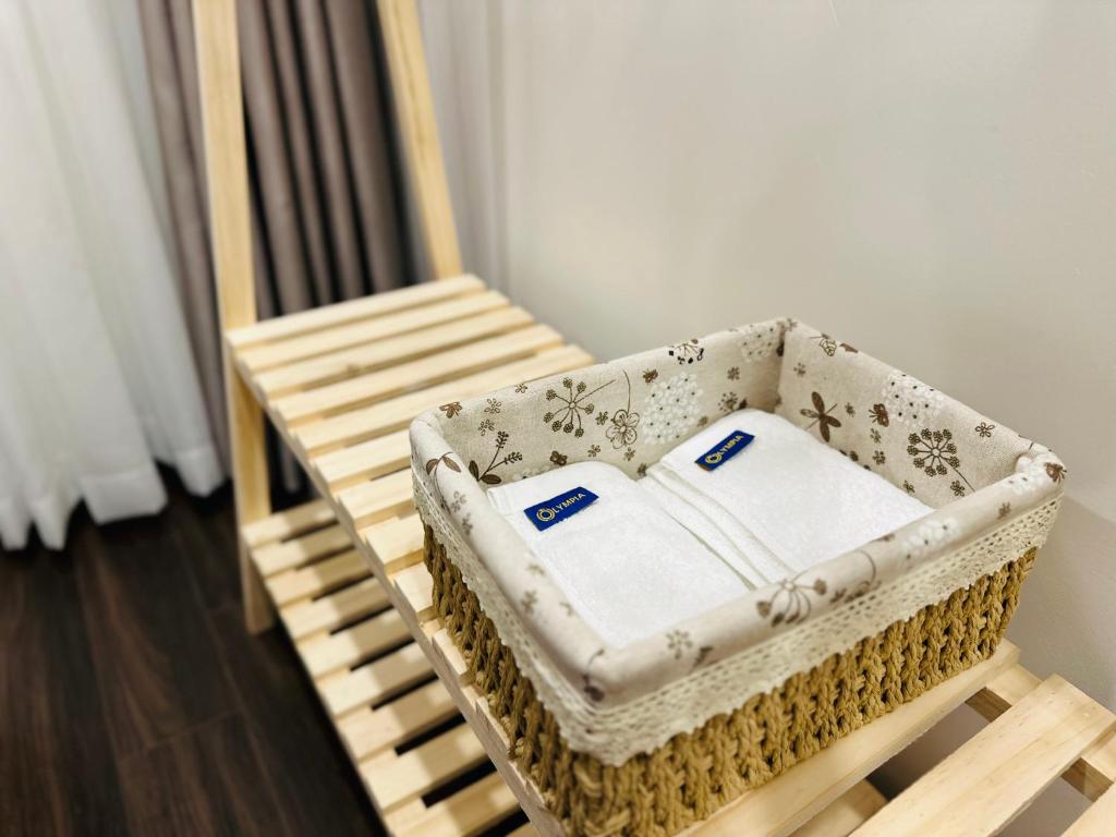 a wicker basket sitting on top of a wooden chair at Hoàng Huy Grand Tower - Jun's Apartment & Homestay in Hai Phong