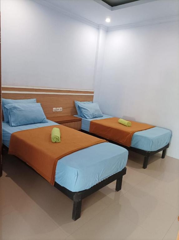 Postel nebo postele na pokoji v ubytování Merendeng Hostel Kuta