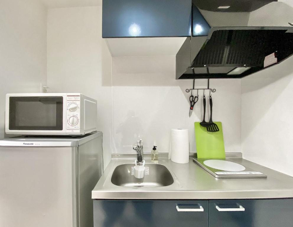 a small kitchen with a sink and a microwave at FL Residence Takadababa - Vacation STAY 9959 in Tokyo