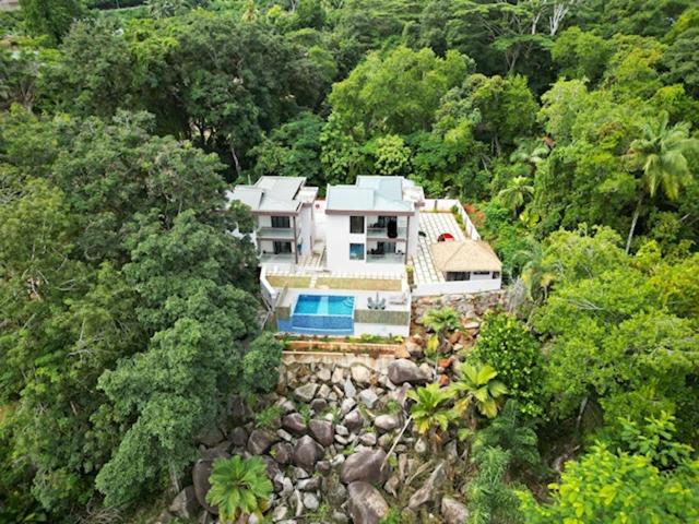 an aerial view of a house in the middle of a forest at RIVERSIDE RETREAT (SEYCHELLES) in Mahe