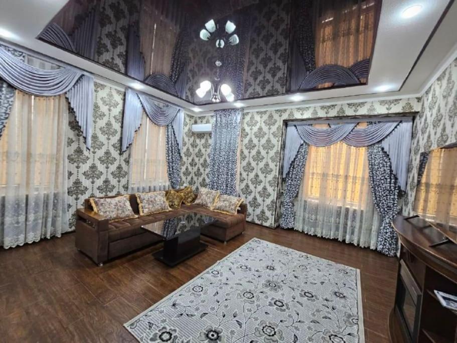 a living room with a couch and a rug at Новая 3-х комнатная квартира Мечта in Bukhara