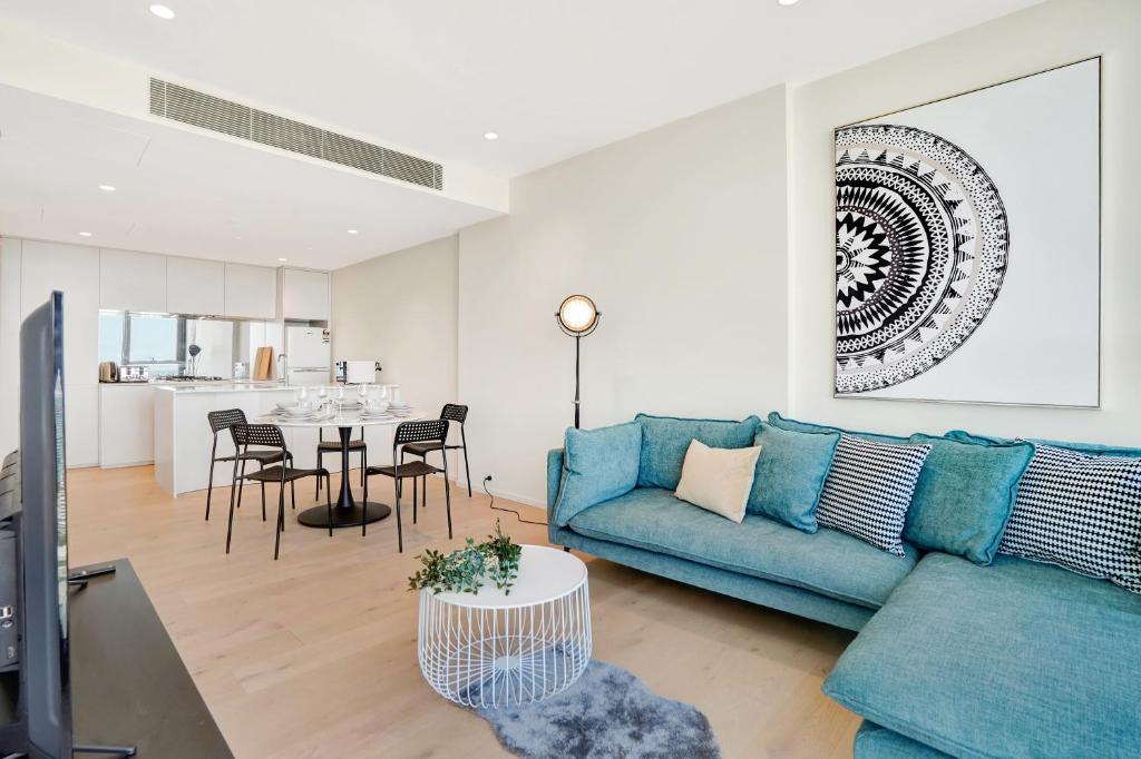 a living room with a blue couch and a table at 3BR 2BATH, Southbank, Crown, Seaview, Level 41 in Melbourne