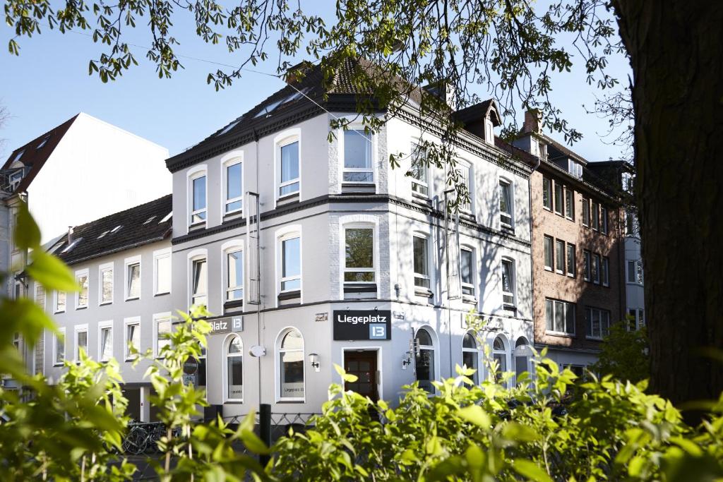 a white building with a sign in front of it at Hotel Liegeplatz 13 Kiel by Premiere Classe in Kiel