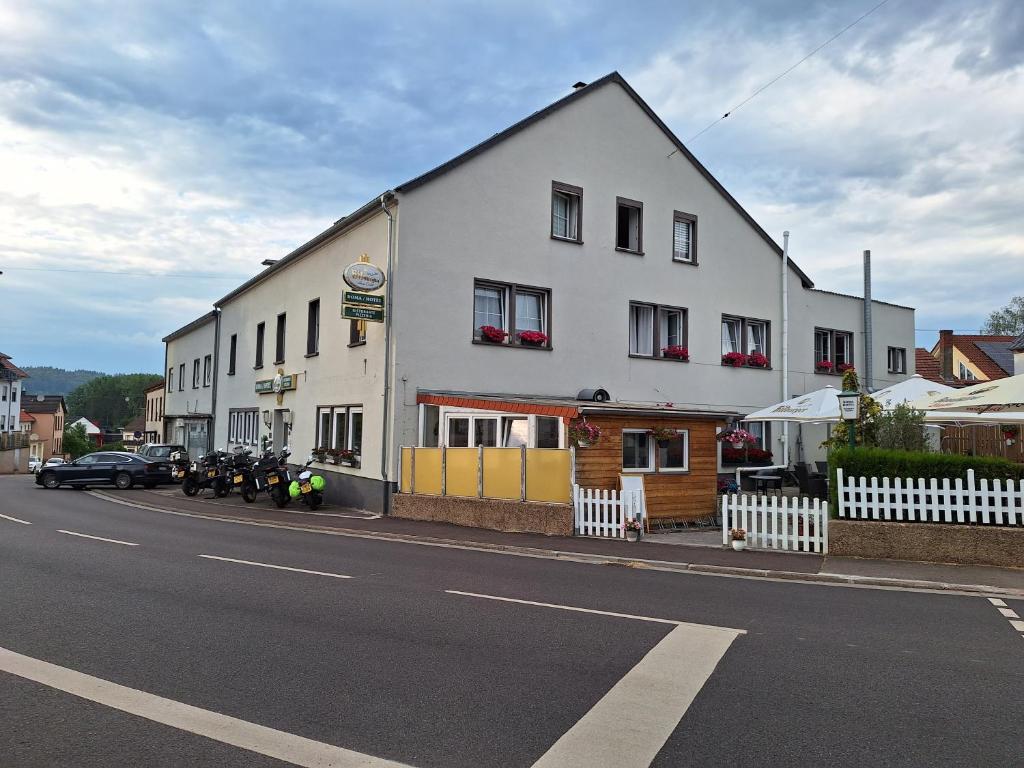 a large white building on the side of a street at Hotel Roma in Merzig