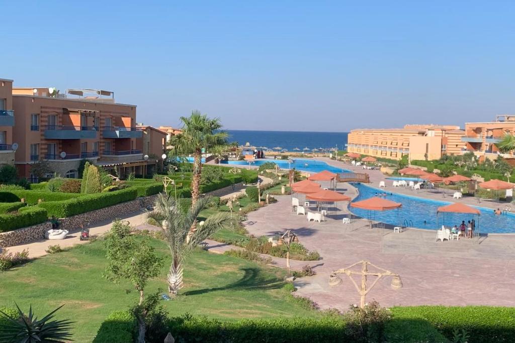 a view of a resort with a swimming pool at Lovely sea & pool view Rental unit, " 3 bedrooms For Families Only" in Ain Sokhna