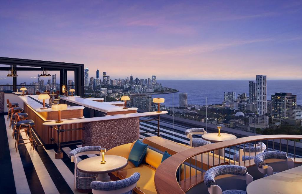 a rooftop bar with a view of the ocean at Four Seasons Hotel Mumbai in Mumbai