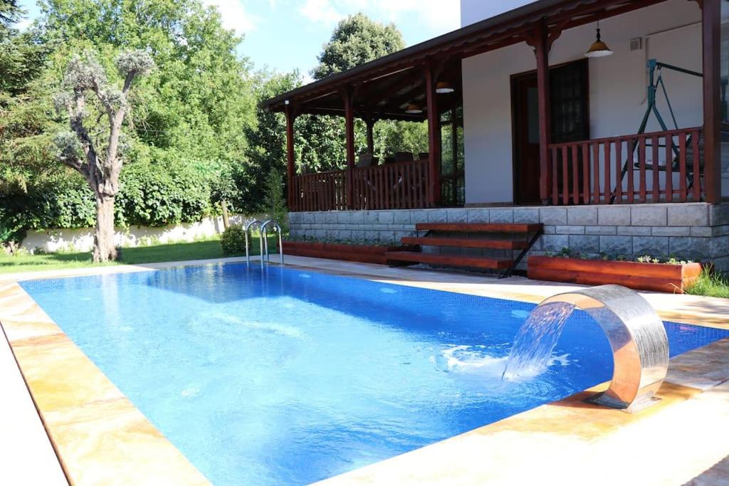 a swimming pool in front of a house at Villa Koral in Kirkpinar - Sapanca in Sapanca