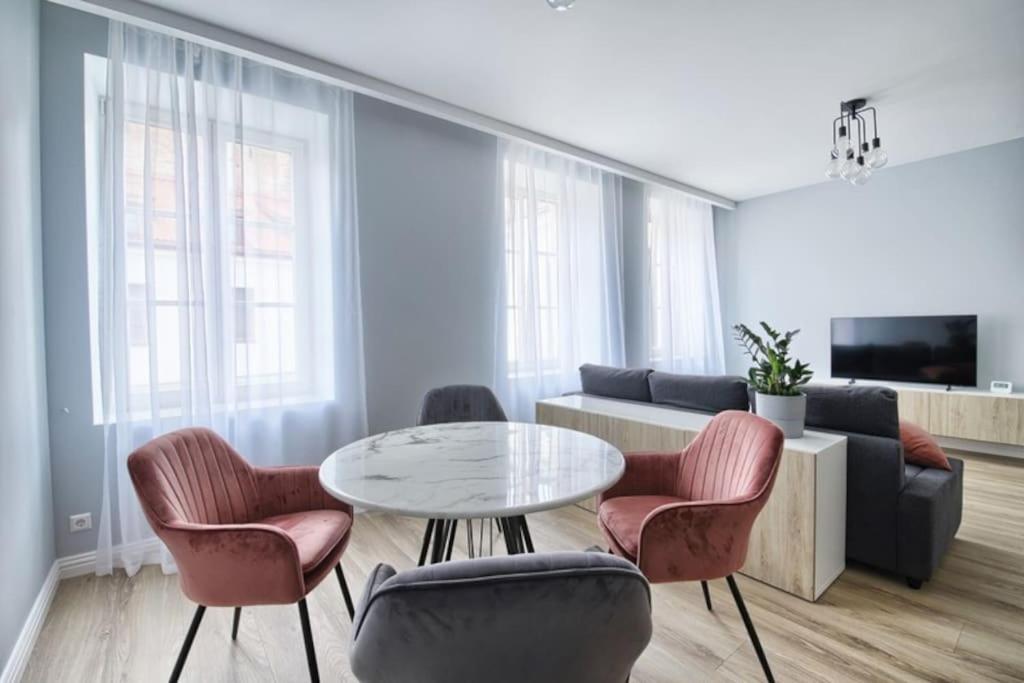 a living room with a table and chairs at Cosy 3 room apartment. in Vilnius