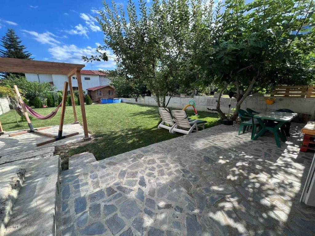 a backyard with a playground and a table and chairs at Вила Полина in Varna City