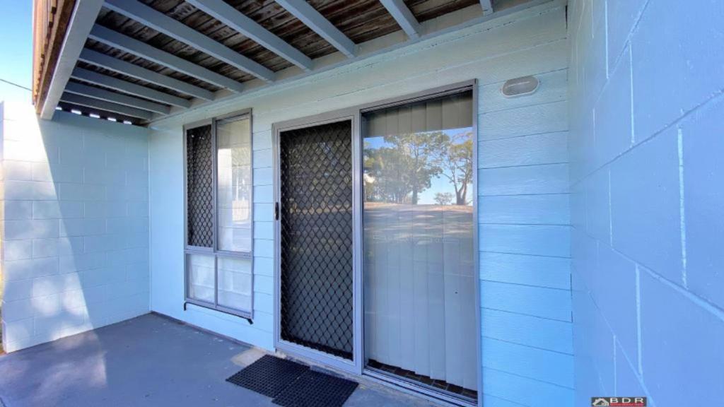 a front door of a house with a window at Ocean Views in Burrum Heads