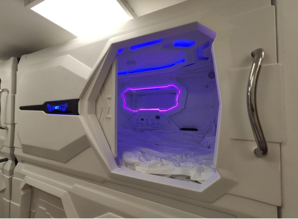 a white drawer with purple lights in a room at CAPSULES & Dormitory BH in Jerusalem