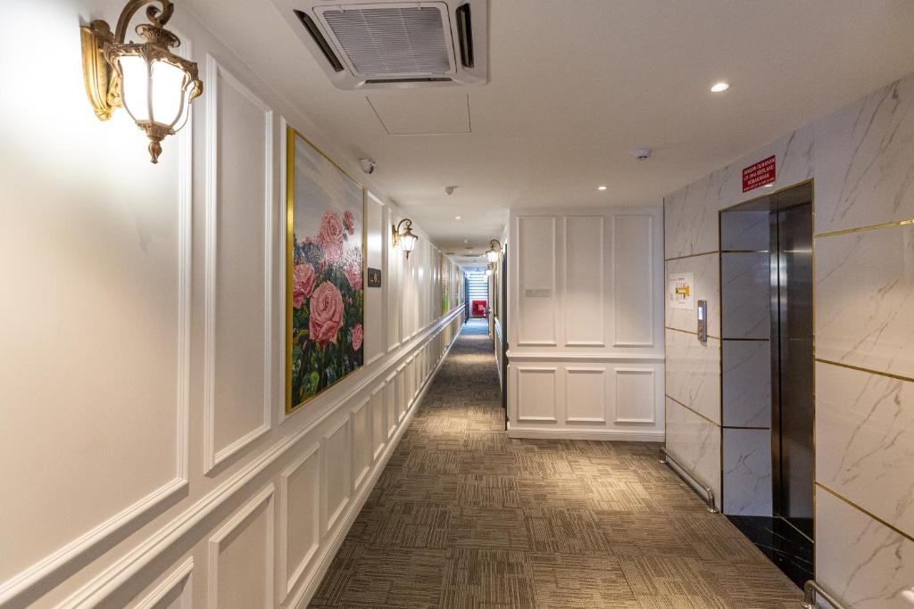 a hallway of a building with a painting on the wall at Frazel Heritage Hotel in Alor Setar