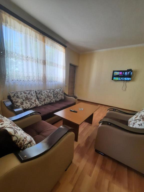 a living room with two couches and a table at Cottage Tsaghkadzor in Tsaghkadzor