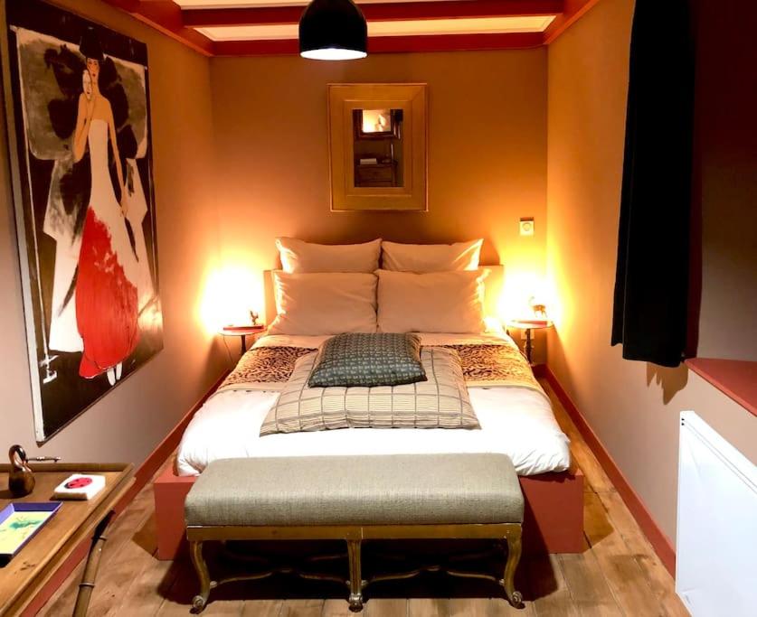 a bedroom with a large bed in a room at Maison en Ardèche avec bain suédois et Sauna in Saint-Symphorien-de-Mahun