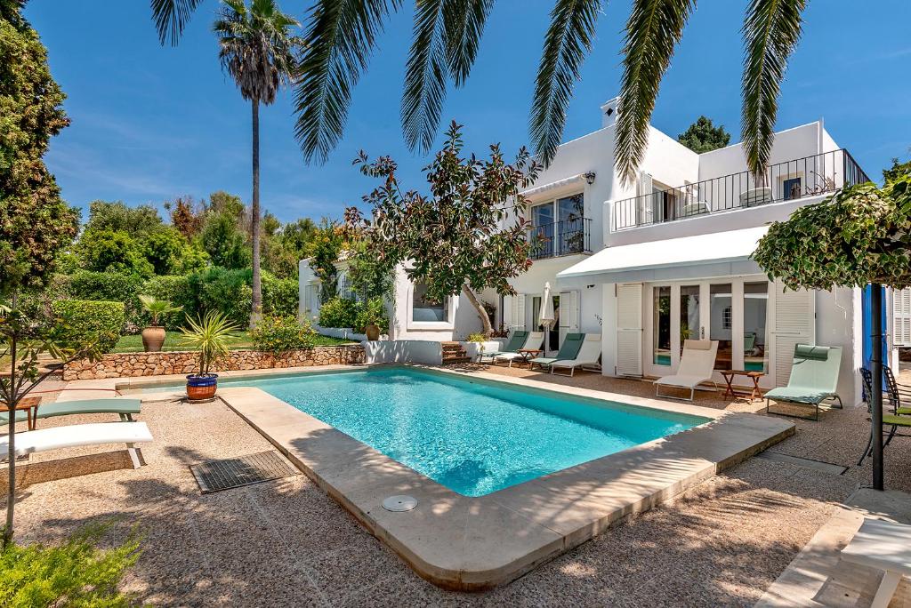 a swimming pool in front of a house at Ca Na Loulou in Cala d´Or